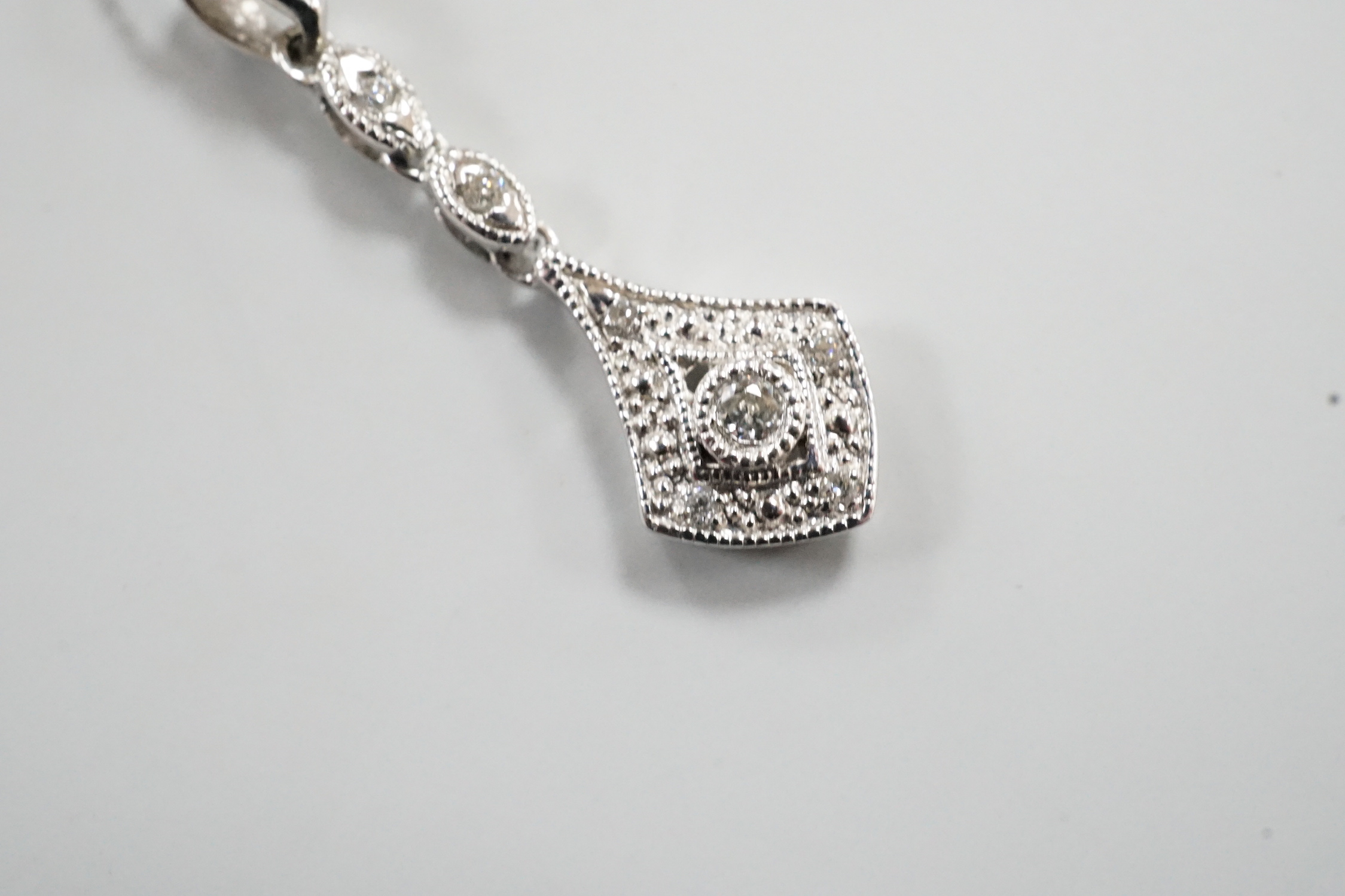 A modern 375 white metal and diamond chip set drop pendant, 23mm, gross 0.6 grams on an 18ct white gold chain, 46cm and one other 18ct white gold chain, 40cm, 18ct gross 2.9 grams.